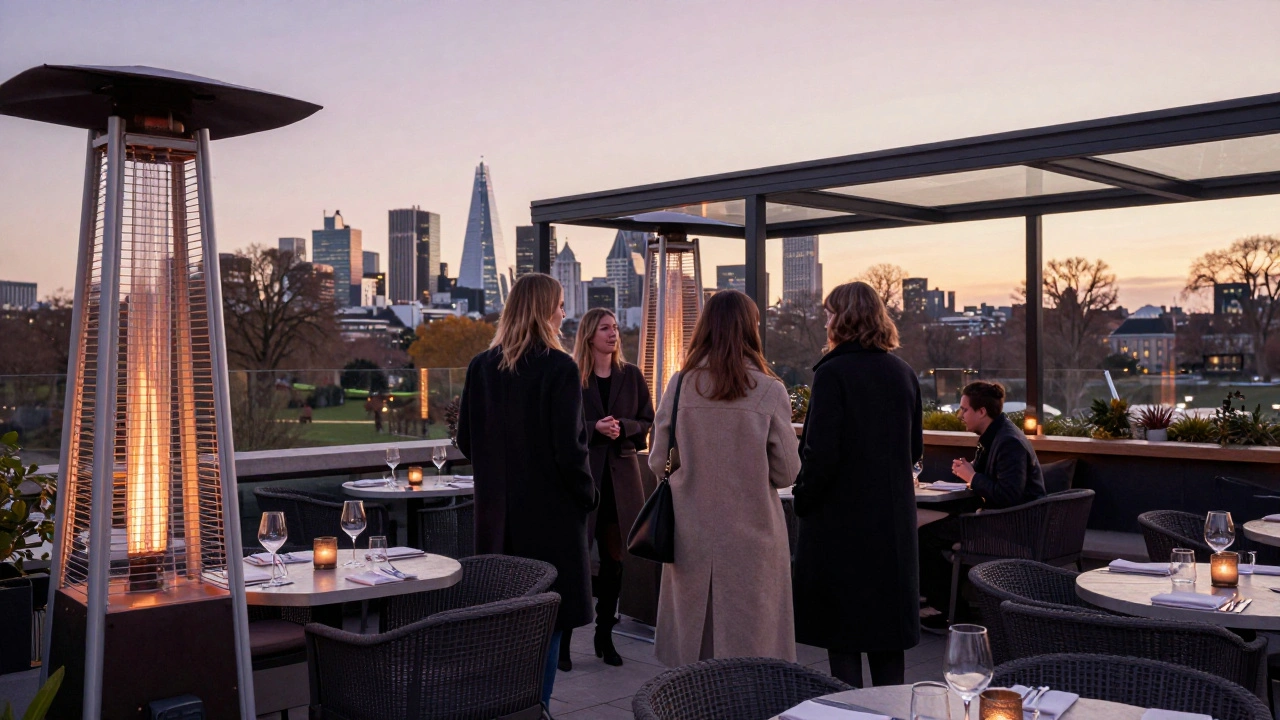 Outdoor rooftop bar terrace with heaters at dusk.